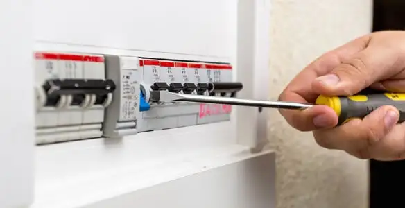electrical panel upgrade service showing technician adjusting circuit breakers during system upgrade in Las Vegas, NV