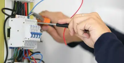 Electrician installing and adjusting circuit breakers in an electrical panel in Las Vegas, NV