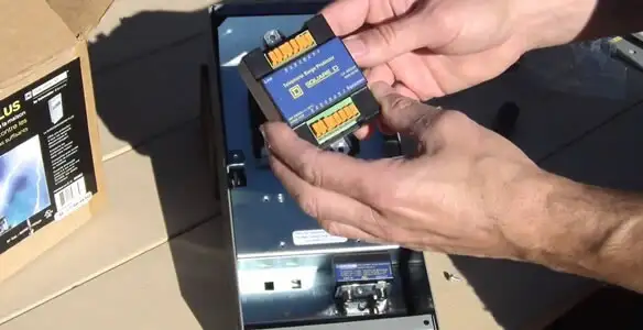 Electrician installing whole home surge protection unit inside main electrical panel in Las Vegas, NV