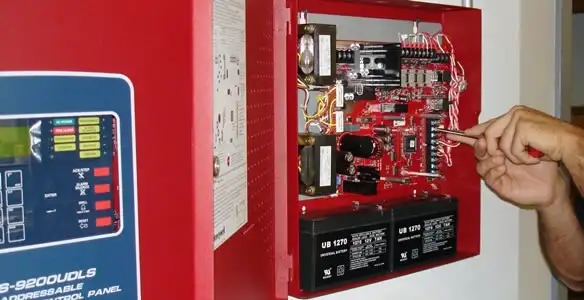 fire alarm installation service showing technician configuring fire alarm control panel in Las Vegas, NV