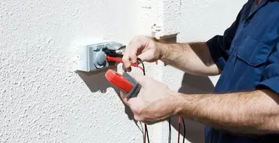 Electrician performing home electrical outlet and wiring inspection in Las Vegas, NV