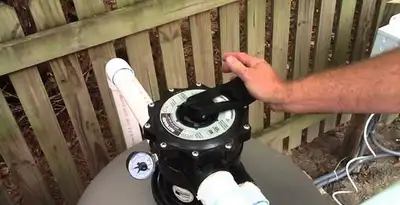 pool pumps service showing professional adjustment of pool pump control system in Las Vegas, NV