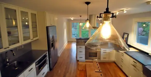 Residential electrician installing modern indoor light fixture in a home in Las Vegas, NV